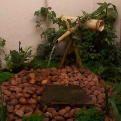 Japanese bamboo water feature, pebbles.