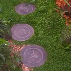 Decorative round concrete Japanese steppingstones with kanji symbols for spring, summer, autumn, winter and yin-yang.