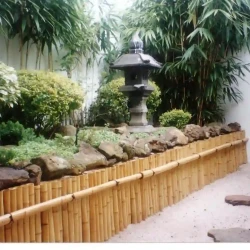 Entrance garden with rocks, Japanese lantern, stones, gravel, bamboo cladding.