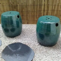 Balcony garden: Ceramic imported stools, also used as little tables, gravel, black slate stepping stones, split bamboo wall cladding